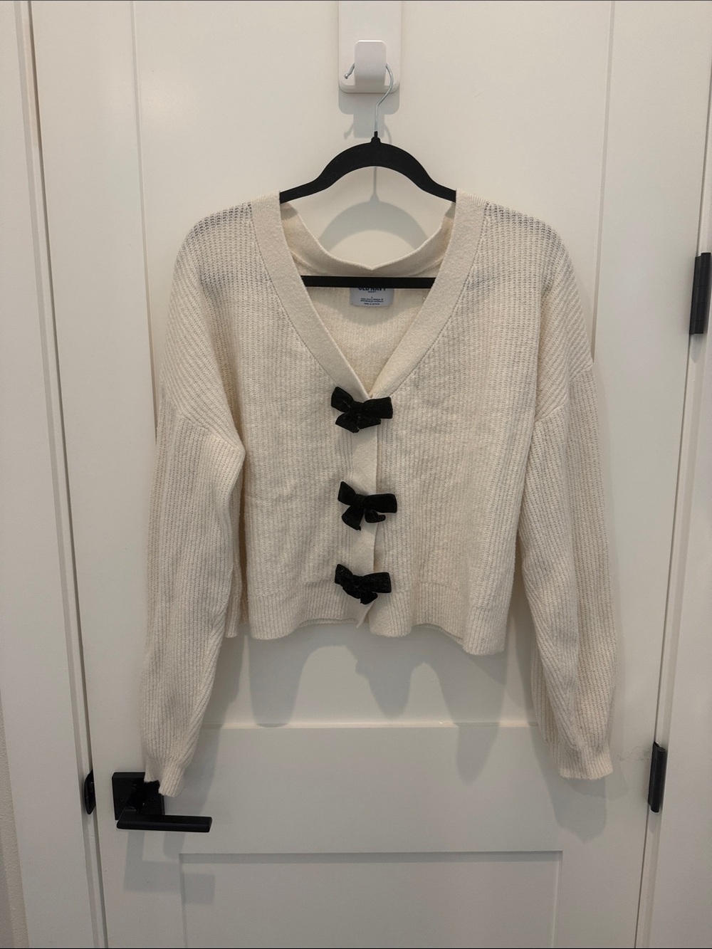 Cream V-Neck Sweater with Black Bows